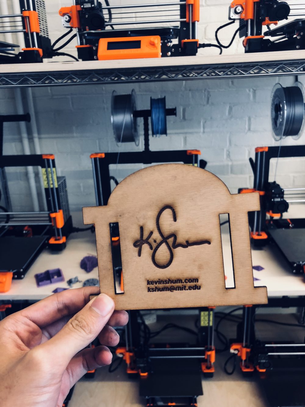 A laser cut business card in the shape of the Big Dome.