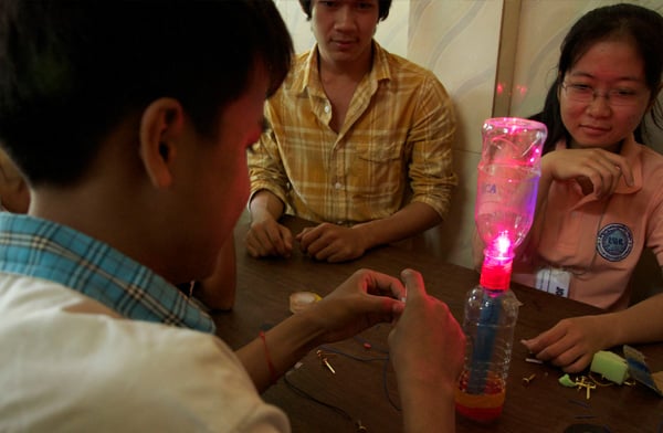 Students at A New Day Cambodia learn about basic circuitry and design their own flashlight using local materials such as old water bottles. Photo: Carolina Kaelin