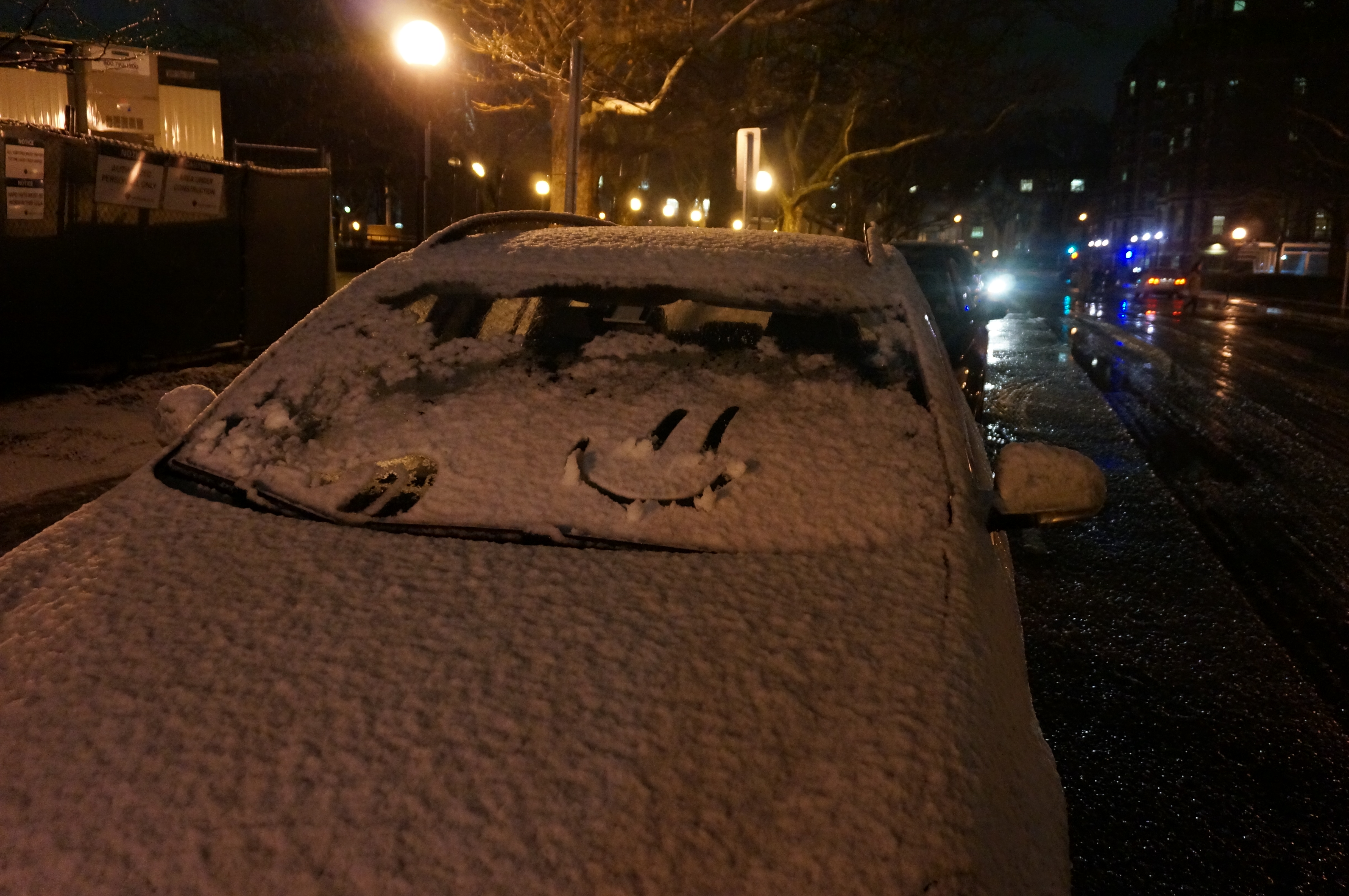 Car covered by snow and a smiley face