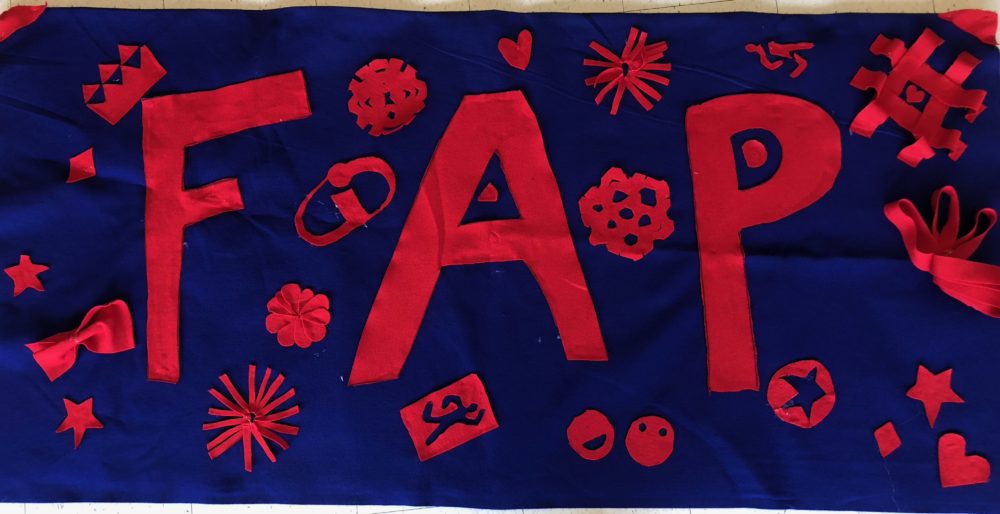 This is the FAP sign. It has big letters for F A P decorated with many random things (from flowers to the incredibles logo (referencing the 2022s orientation theme) to snowflakes around it. 