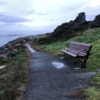 park 1 (gravel path, with bench and grass on one side, and the sea on…