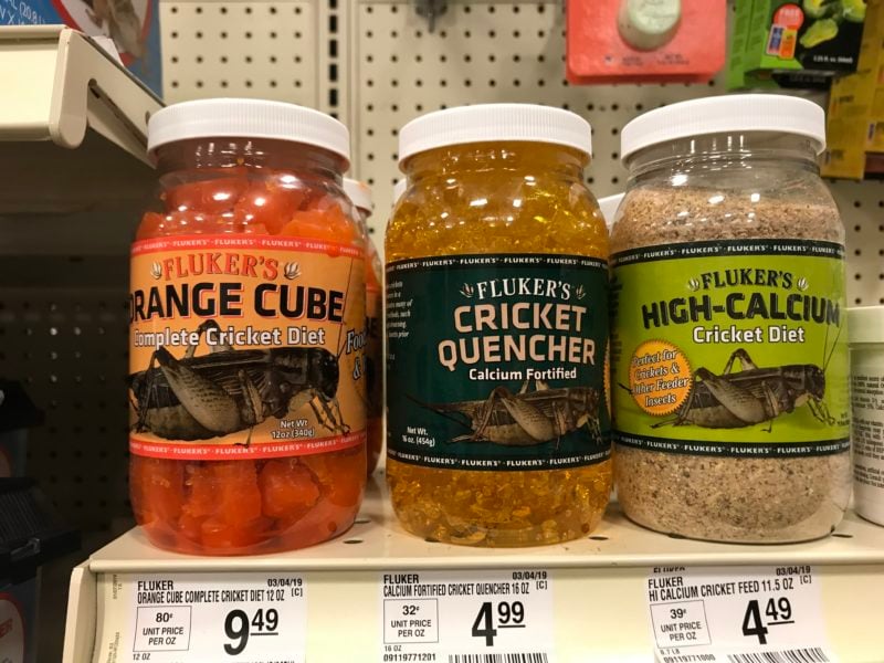 three jars of cricket food on a shelf