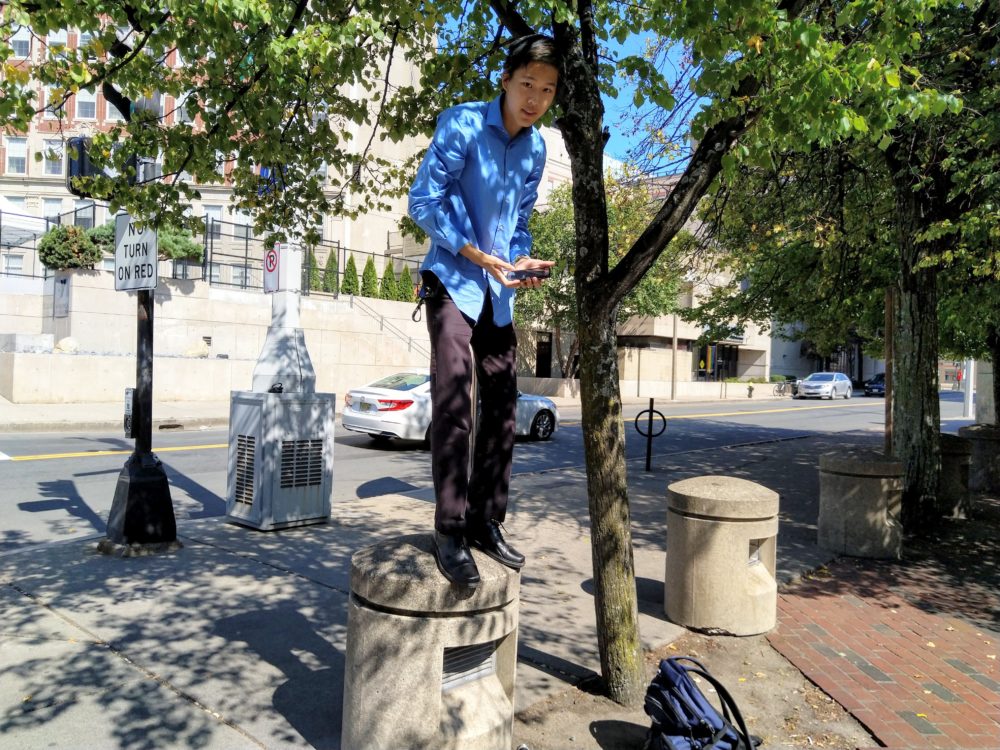 alan z. ’23 stands on top of a small post to take the previous picture.