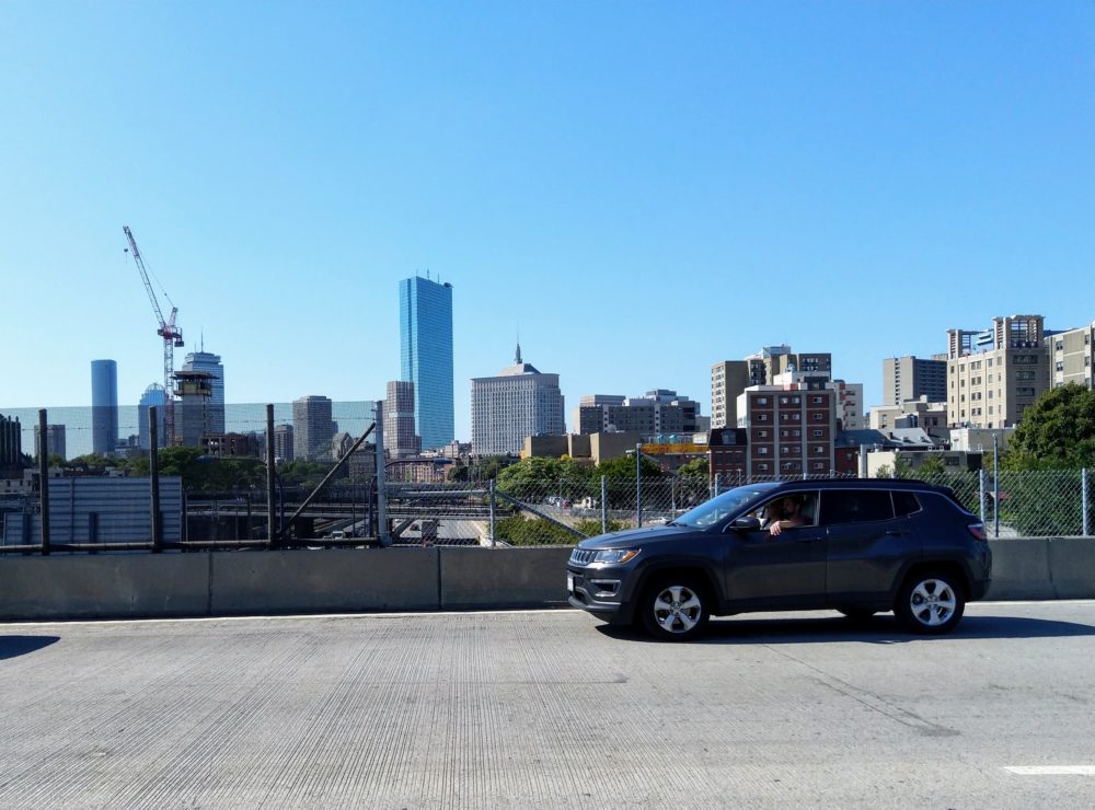 a boston skyline, as viewed from the highway