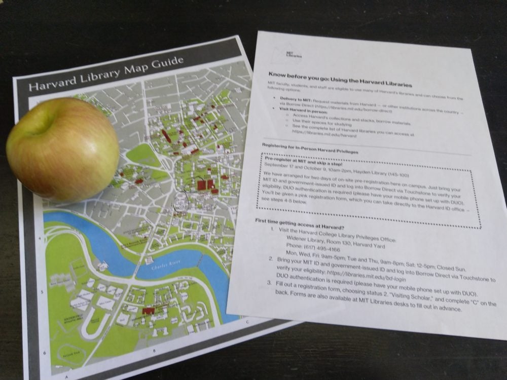 an apple, a map of harvard, and a guide to get a harvard library card