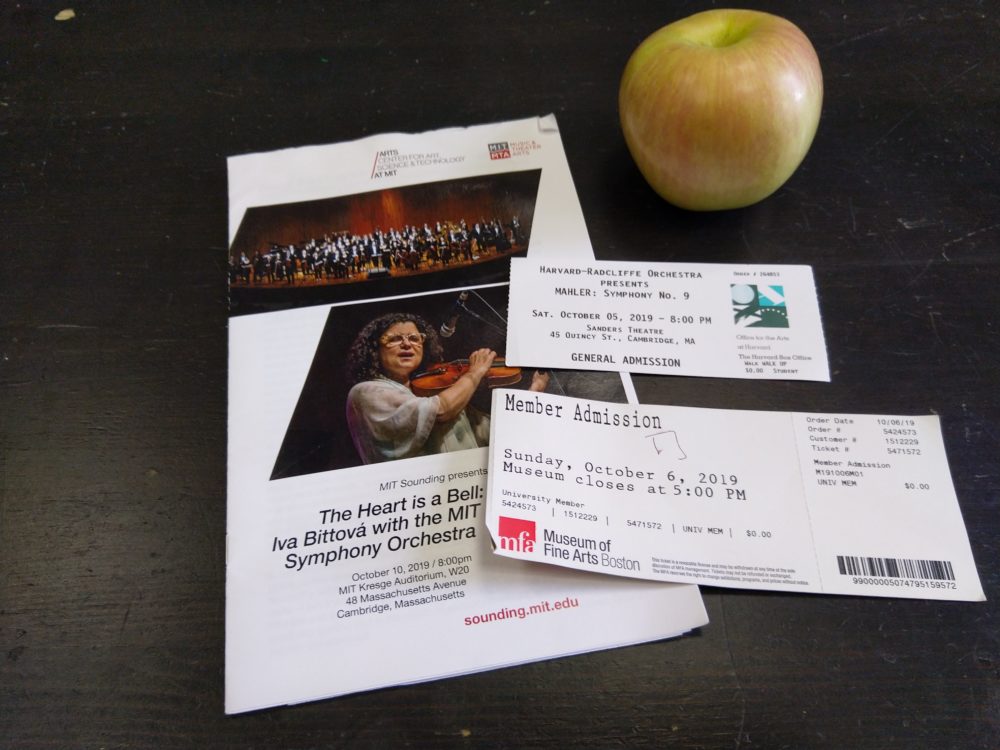 an apple, two tickets, and a pamphlet