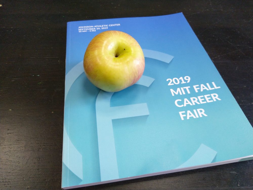 an apple on a career fair booklet