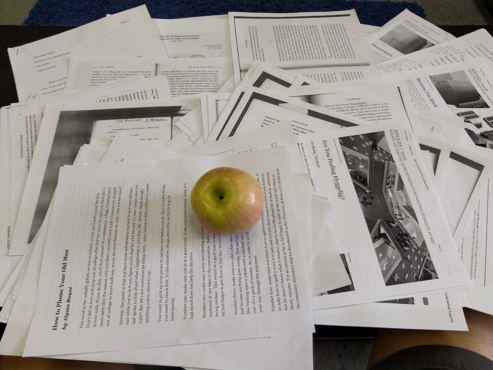 an apple over LOTS of papers