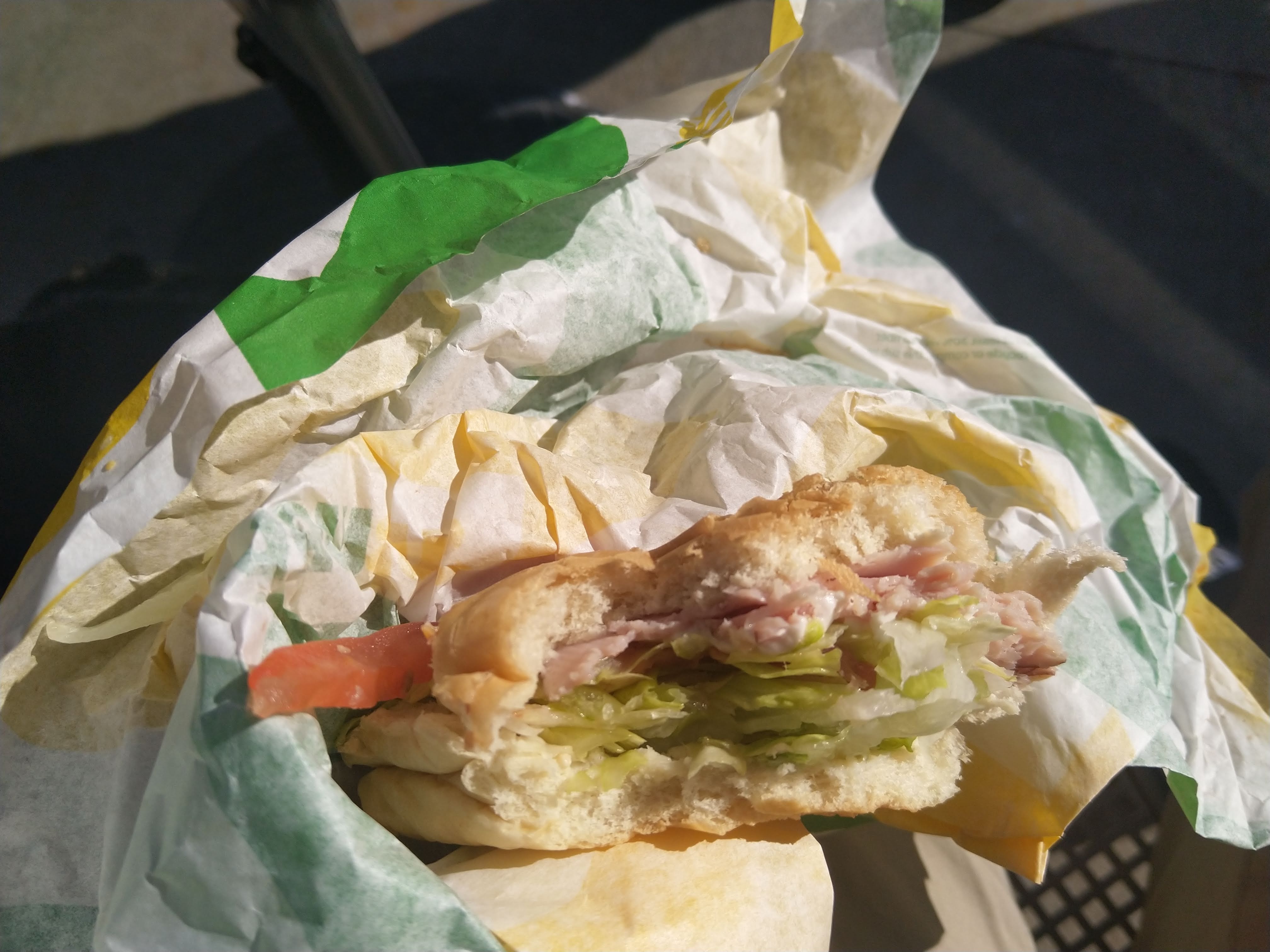 a half-eaten subway sandwich
