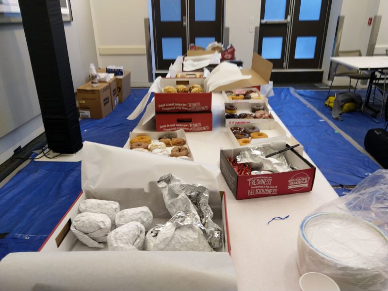 a table with bagels and donuts