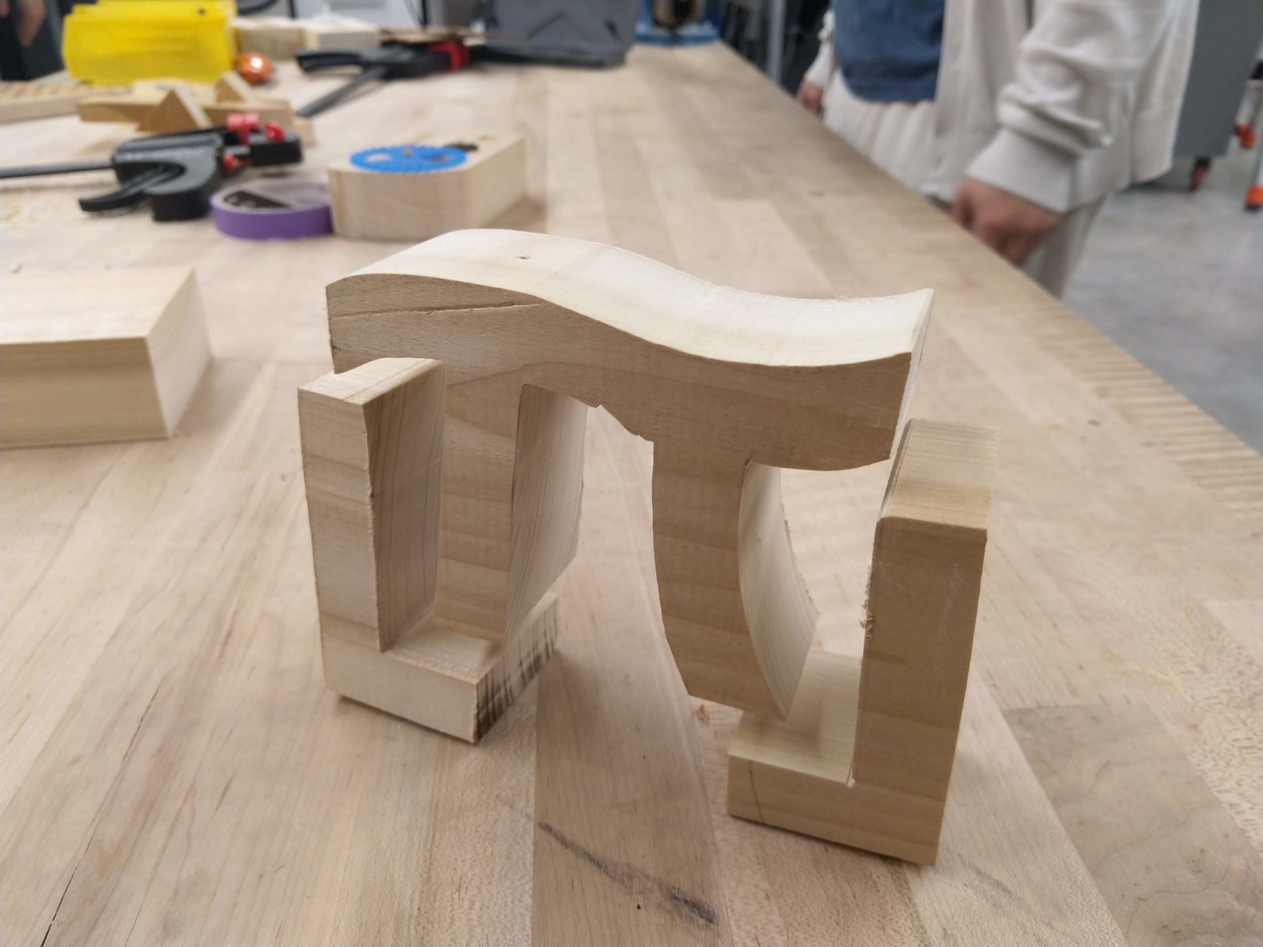 a pi made out of wood, seemingly floating on top of a floor symbol