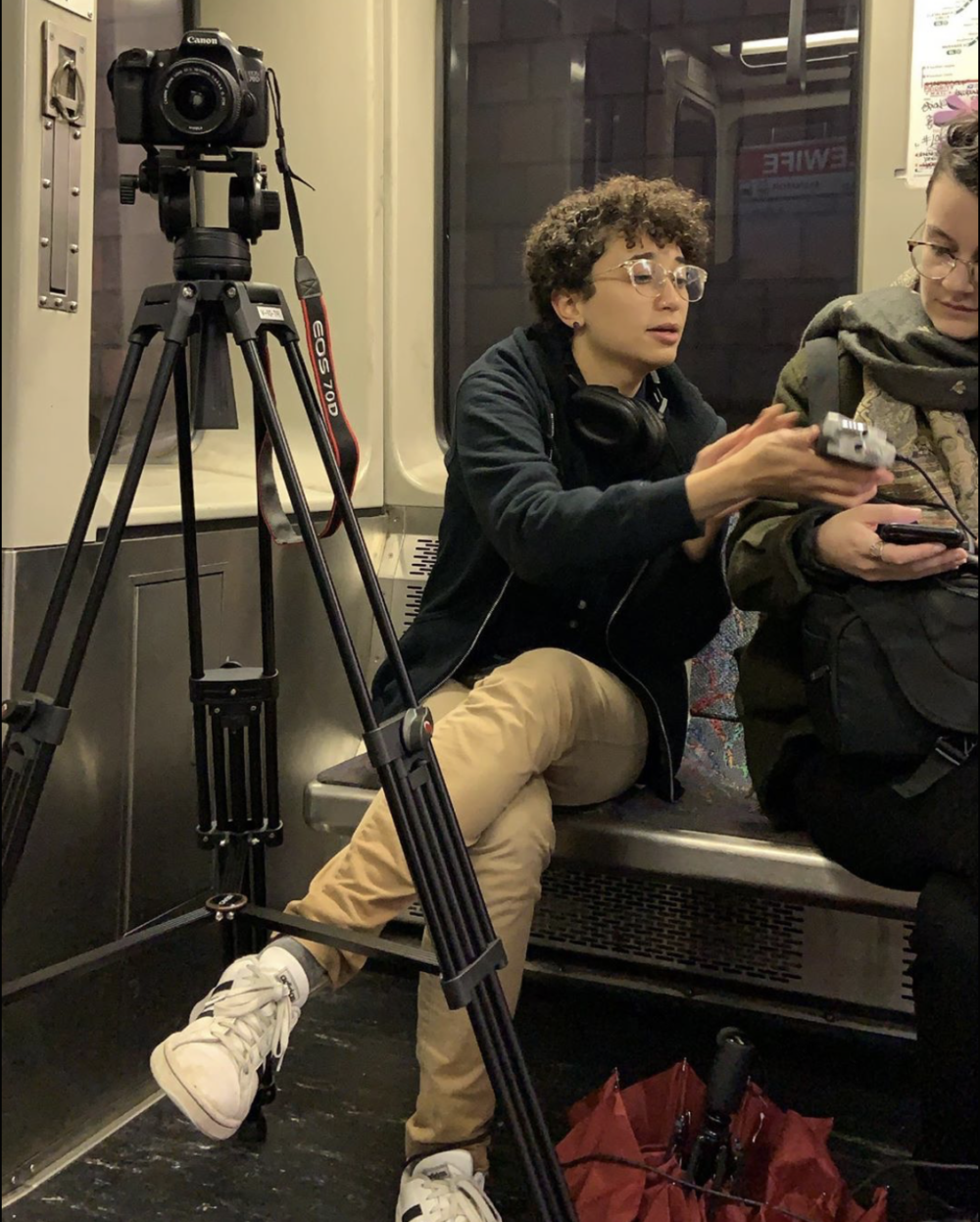 a picture of me and a tripod/camera set up on the train car