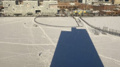 the shadow of my dorm building on a snowy field