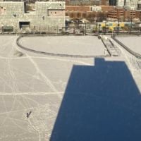 the shadow of my dorm building on a snowy field
