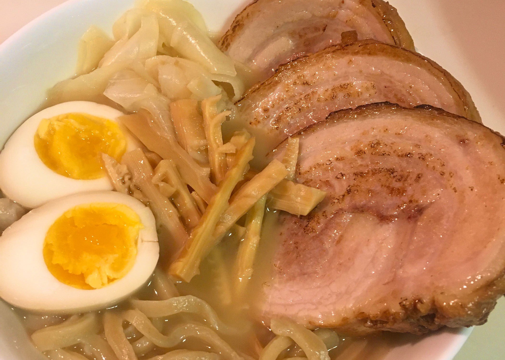 a bowl of ramen! visible are noodles eggs and pork belly