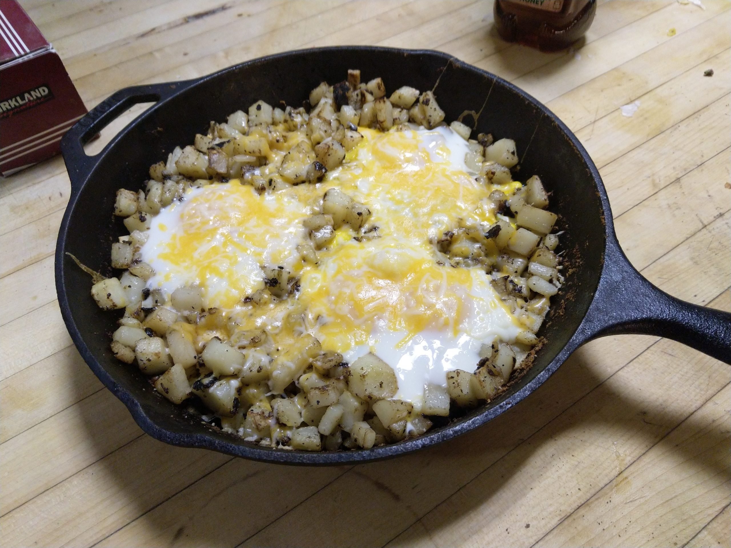 eggs potatoes and cheese in a cast iron pan