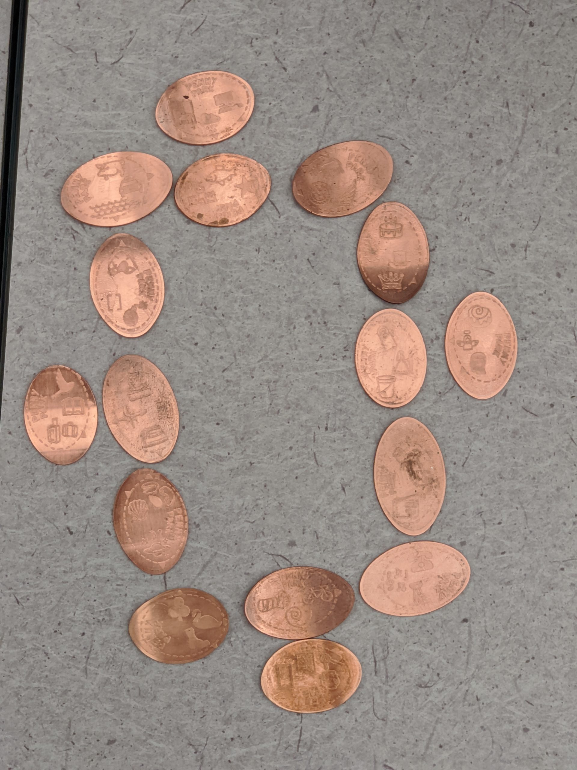 the sixteen pressed pennies laid out in a nice arrangement