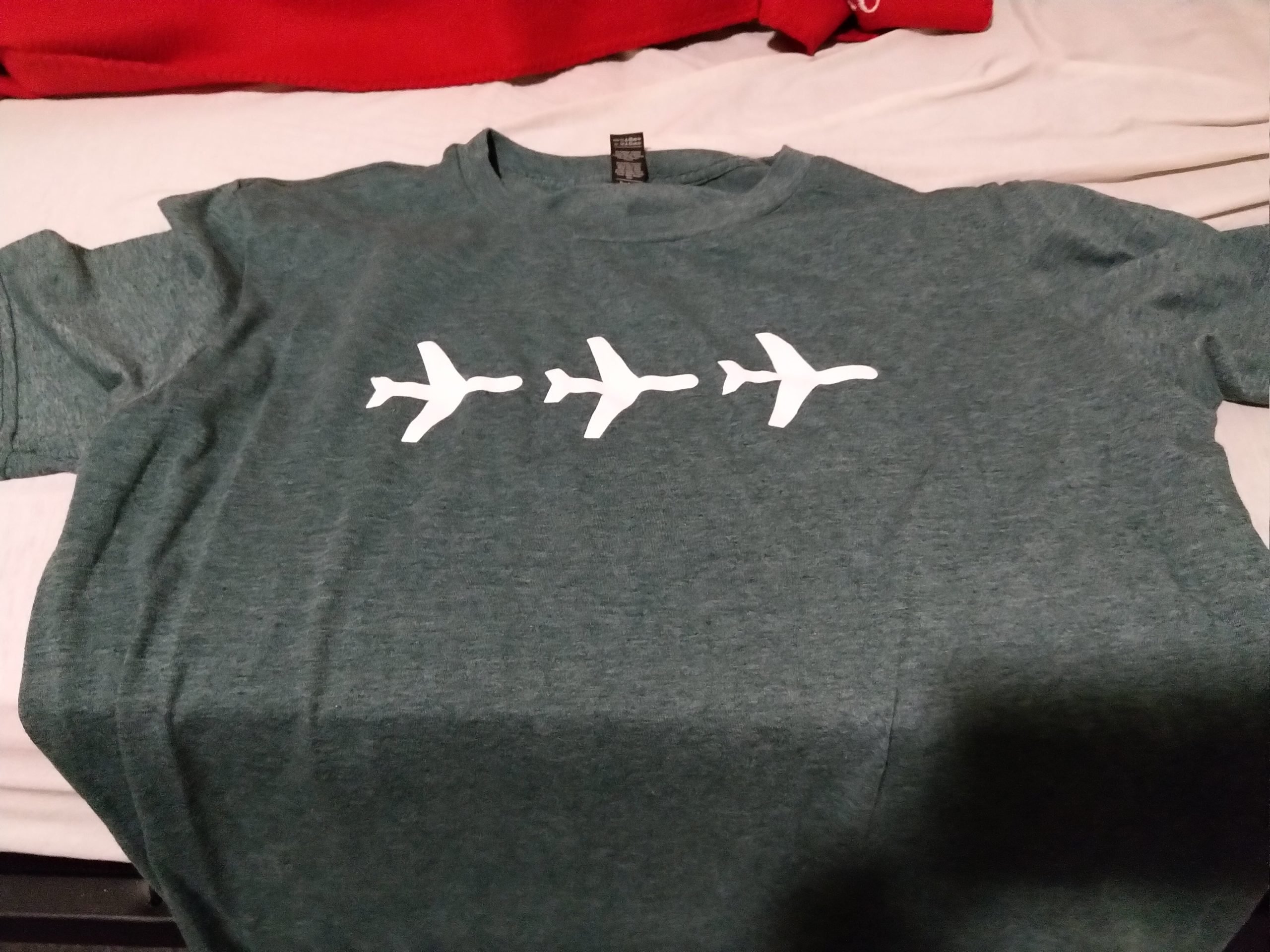 a green shirt with three planes