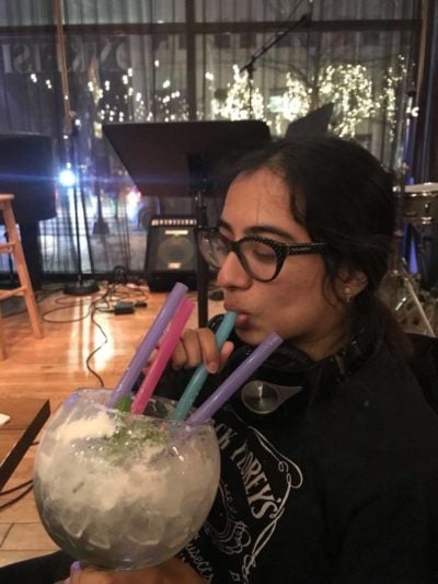 nisha drinking a very large alcohol drink