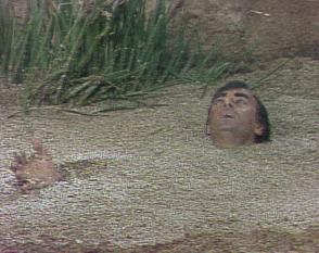 a gif of a person sinking into quicksand