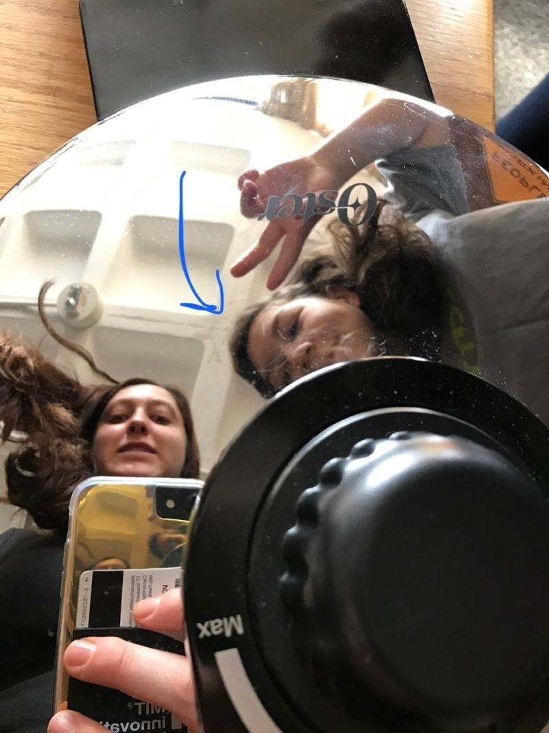 a selfie in the reflection of the waffle maker