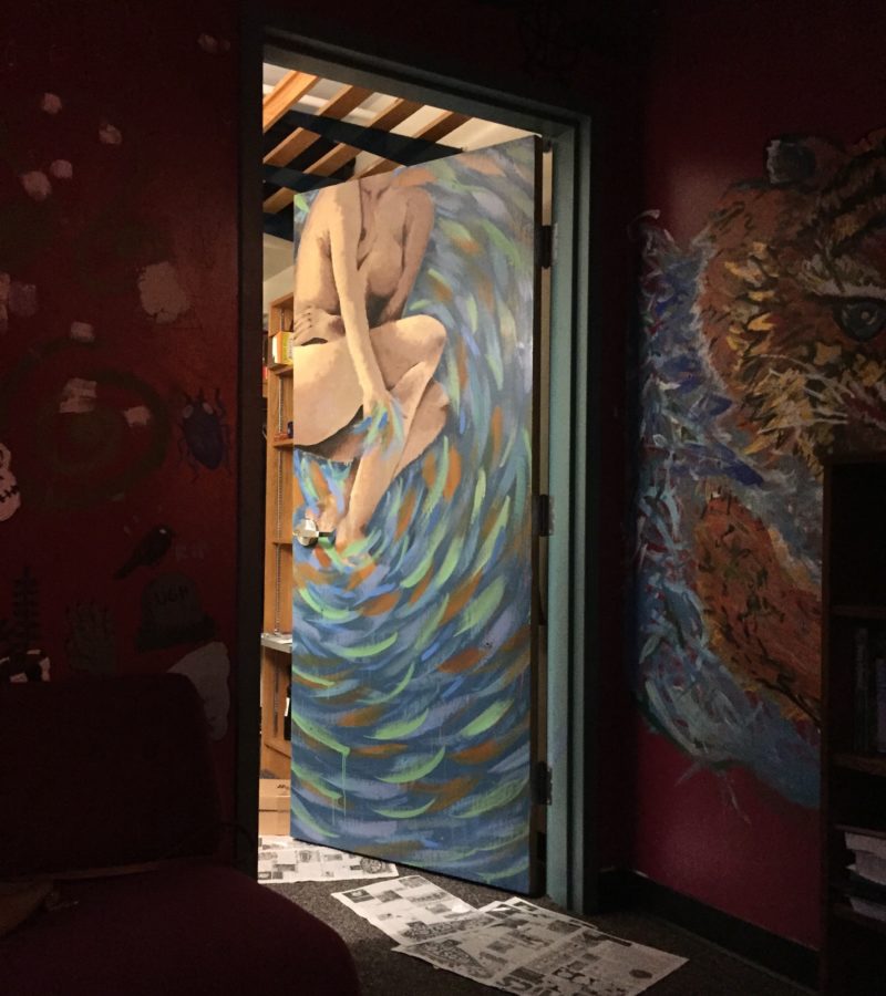 a photo of my door, with a woman surrounded by swirls painted on it