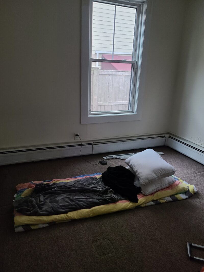 literally three blankets on a floor with some pillows
