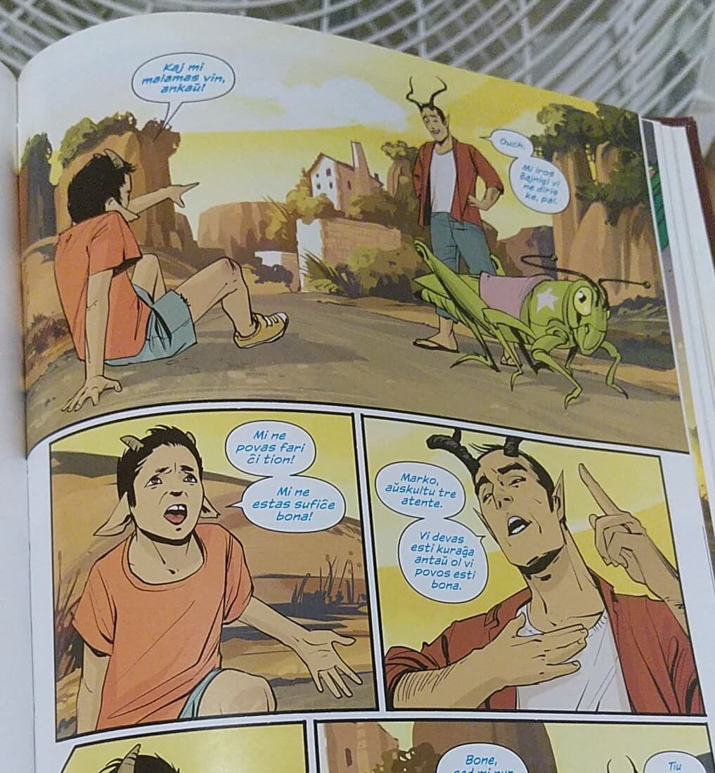 some panels from saga. two characters, a son and his father, speak in esperanto. they both have horns.