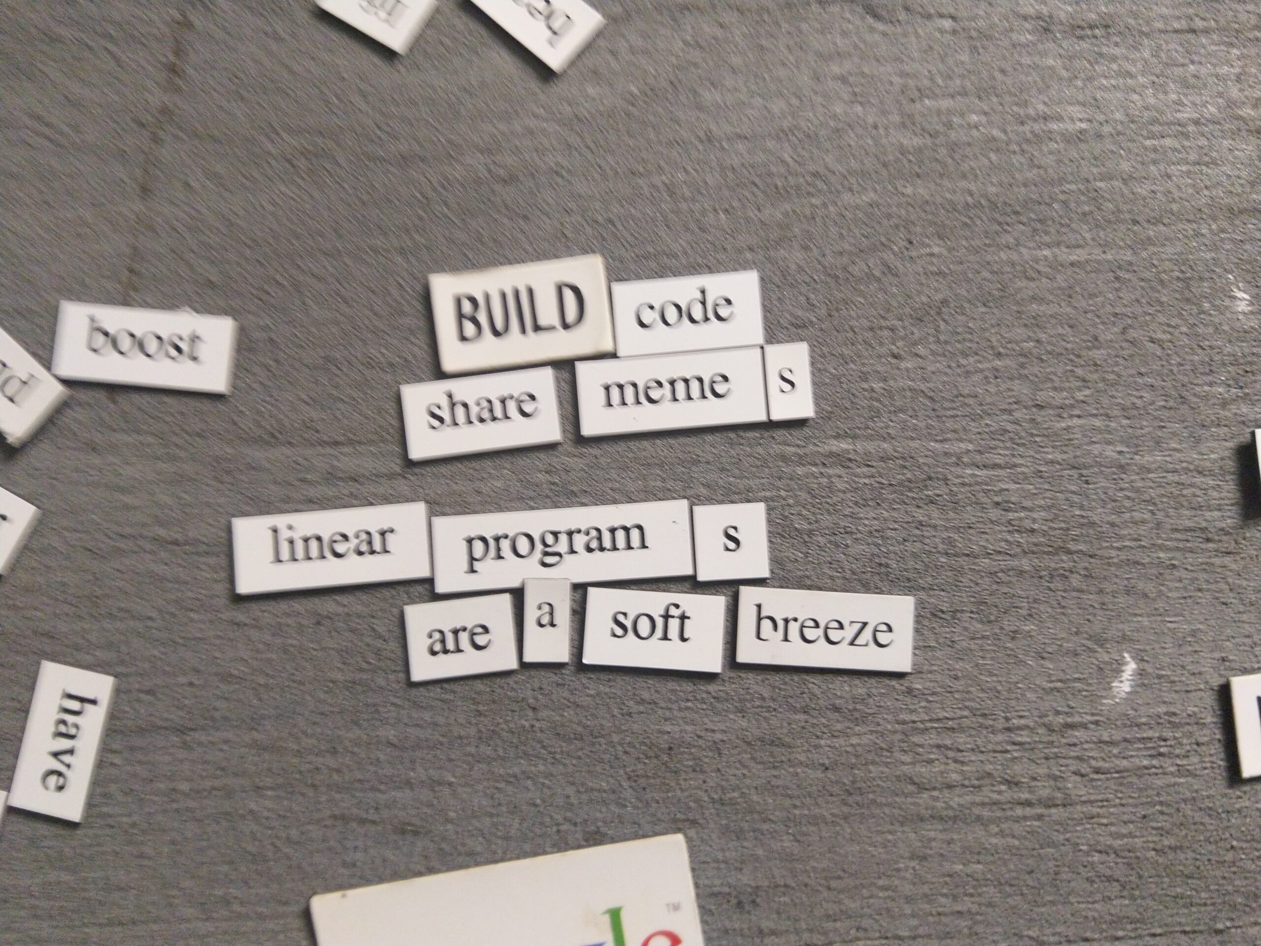 magnetic poetry: build code / share memes / linear programs / are a soft breeze