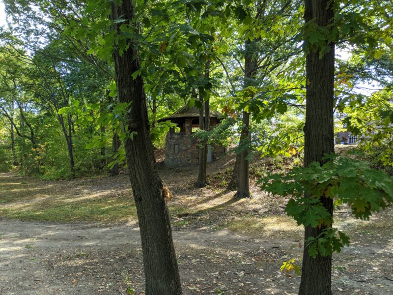 a round shelter through some trees