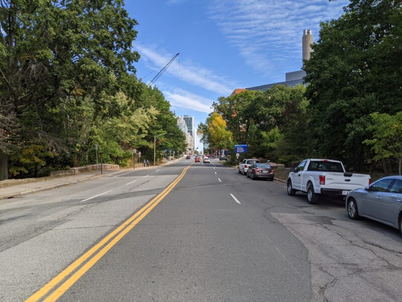 a four-lane street with the Citgo sign in the distance