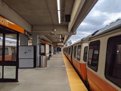 another shot of two orange line trains at oak grove station