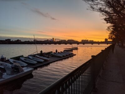 sunset over boats on the charles river