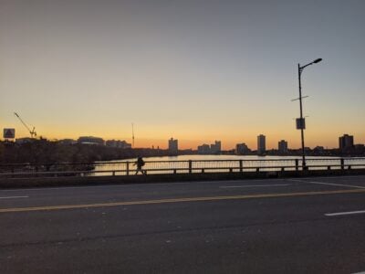 orange wraps the horizon over harvard bridge and the charles river