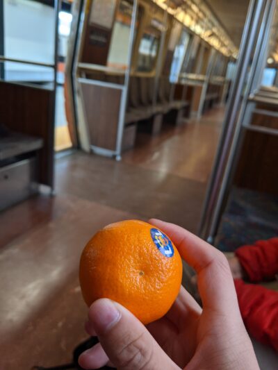 small orange with an orange line train as background