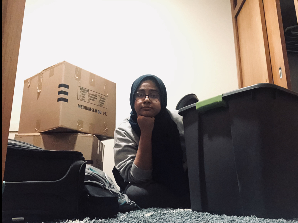 Surrounded by packing boxes