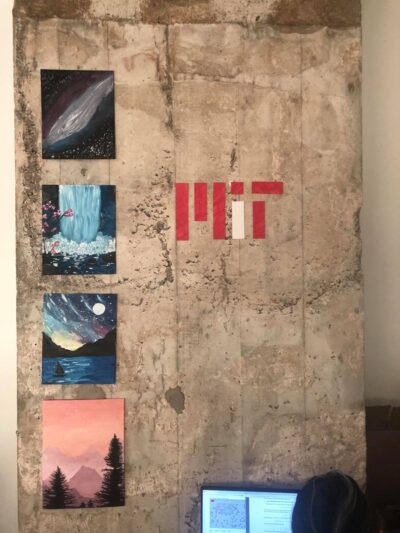 image of apartment wall with four paintings and an mit logo