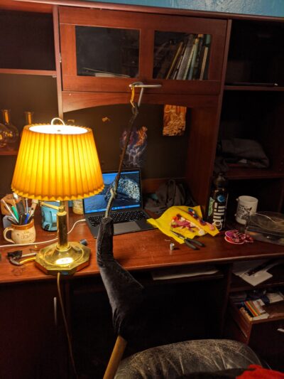 desk with lamp, thread and tools, and computer