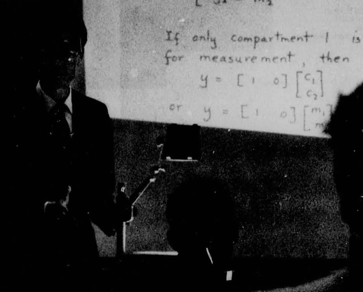 picture of person lecturing with overhead transparencies