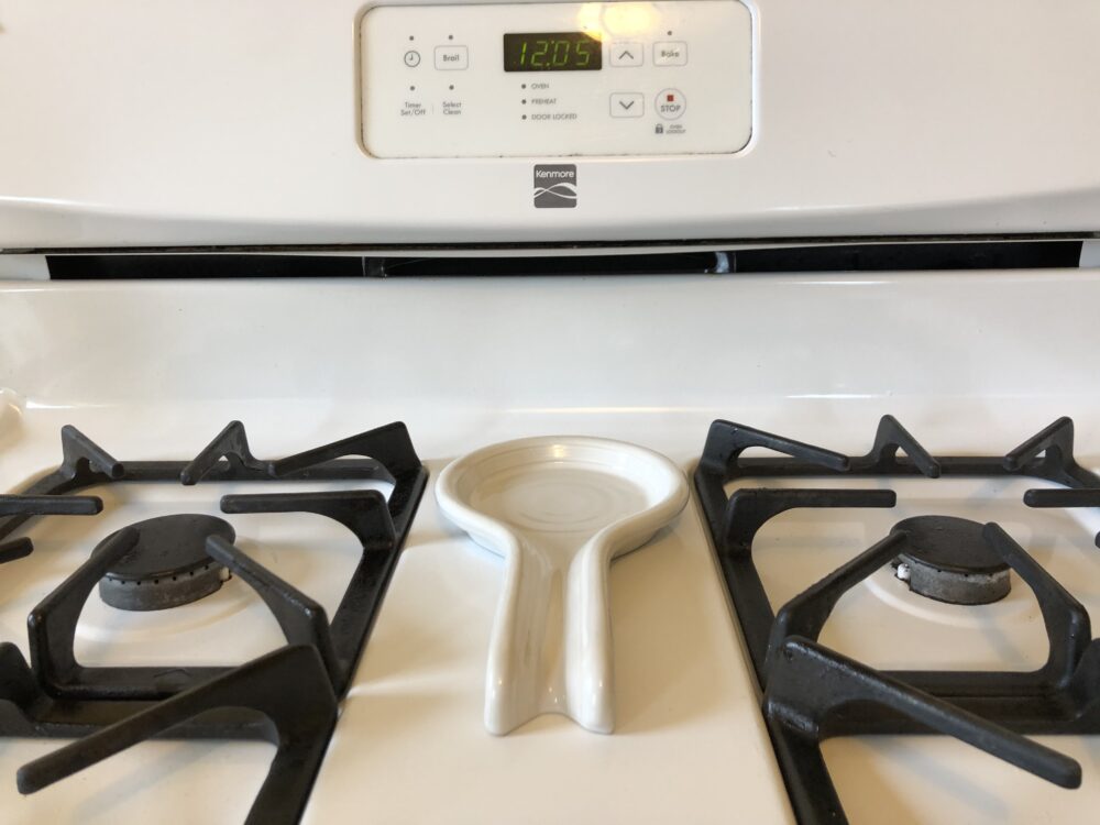 a photo of a spoon rest on the stove