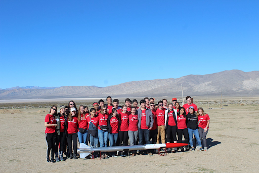 team picture behind Hermes III which lies horizontally on stands in the Mojave Desert