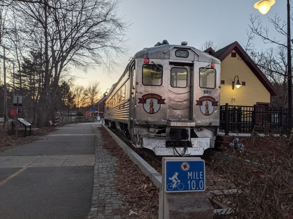 train at the end of bike path at sunset with 10 mile marker