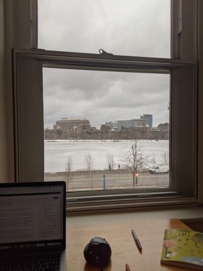 window looking out on the charles river, which is covered in snow