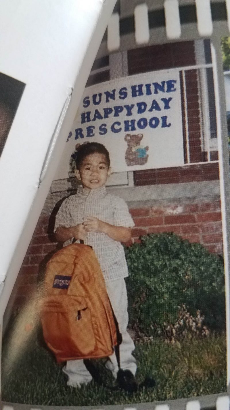 paolo in front of preschool holding orange backpack