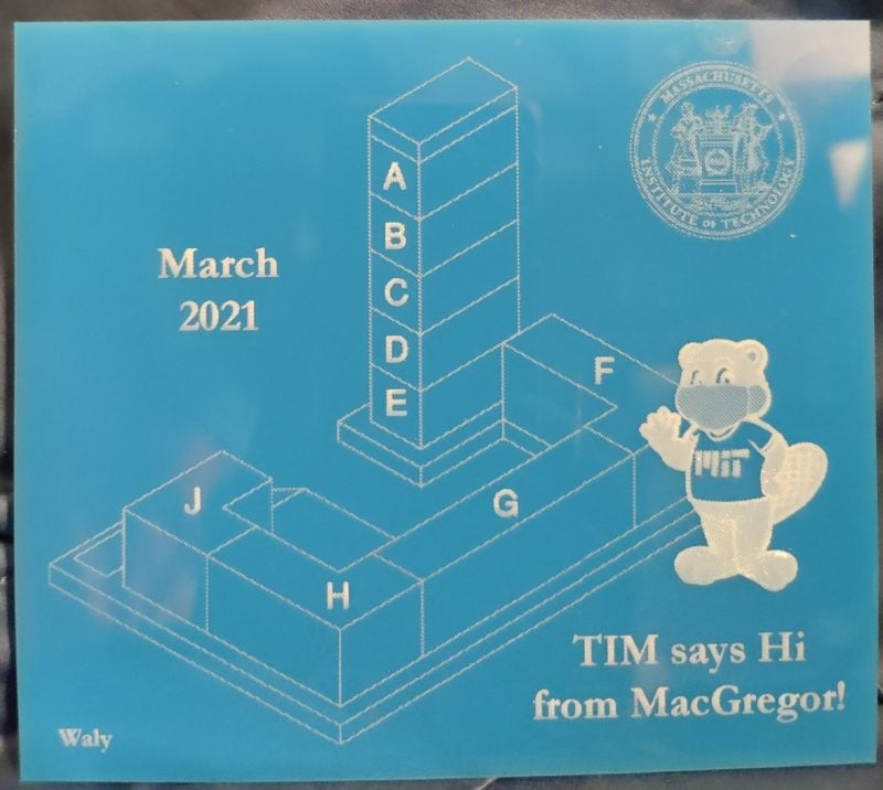 a laser cut blue acrylic with macgregor and tim the beaver on it