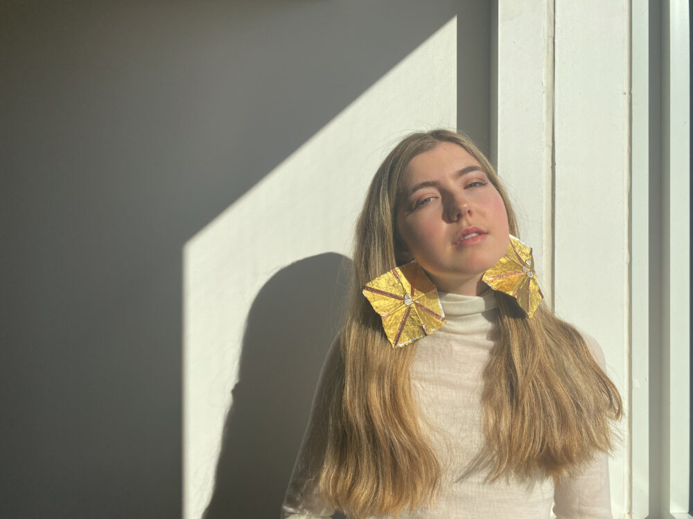 portrait of woman with gold foil earrings