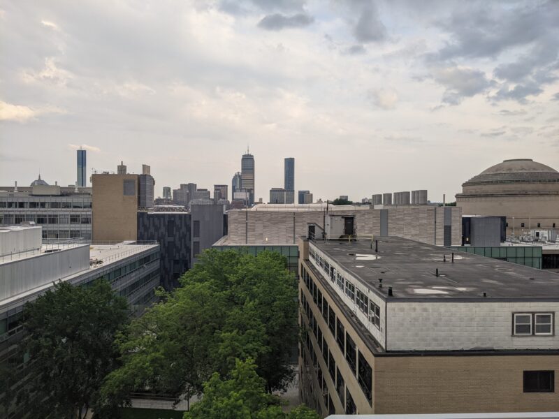 the back of MIT's main group against the Boston skyline