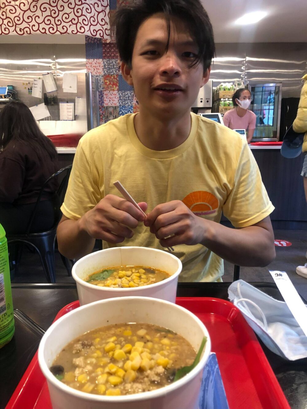 raymond with two bowls of ramen in front of him