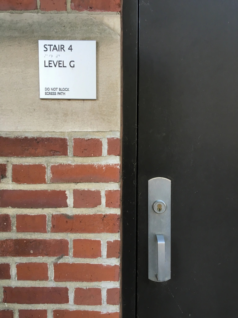 door on brick wall with "stair 4, level g"