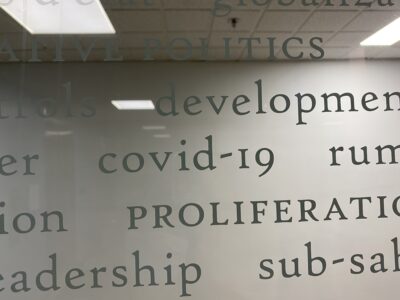 picture of the glass wall zoomed into the words "covid-19"